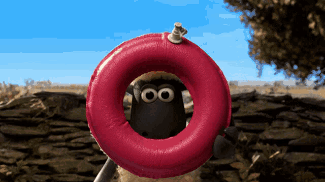 a cartoon sheep is holding a red ring around his neck