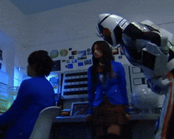 a man in a robot costume is standing next to a girl in a blue jacket