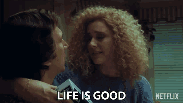a netflix ad shows a man and woman hugging and the woman says " life is good "