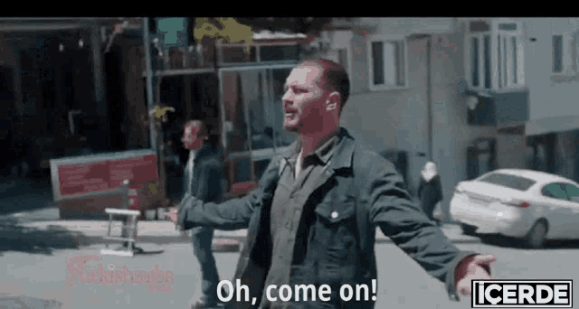 a man with his arms outstretched is saying " oh come on "
