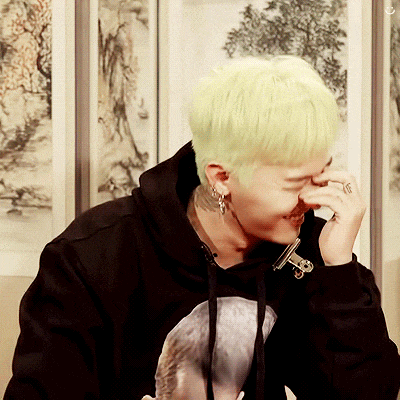 a man with a ring on his finger is covering his nose with his hand