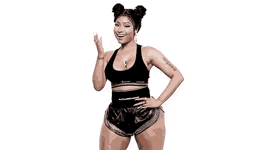 a woman in a black tank top and shorts is standing with her hand on her hip and smiling .