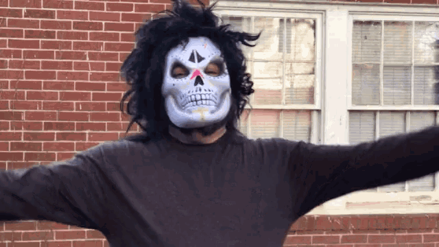 a man wearing a day of the dead mask