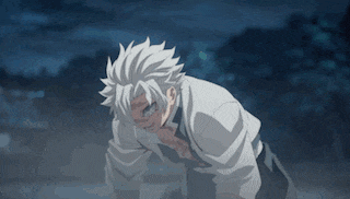 a man with white hair is kneeling down with his hands on his chest