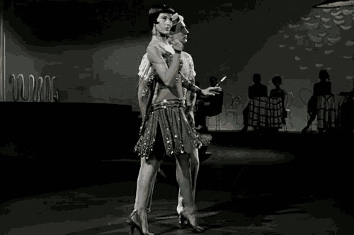 a man and a woman are dancing in a black and white photo