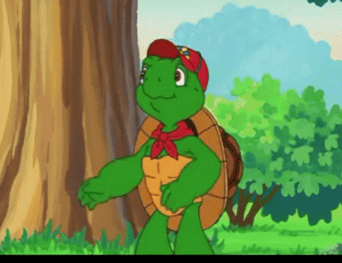 a green turtle wearing a red hat and a red bow