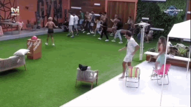 a group of people are dancing in front of a tv screen that says the brother