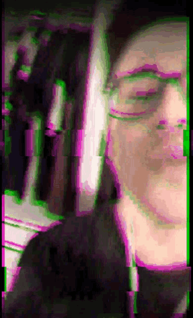 a blurry picture of a person with glasses and headphones
