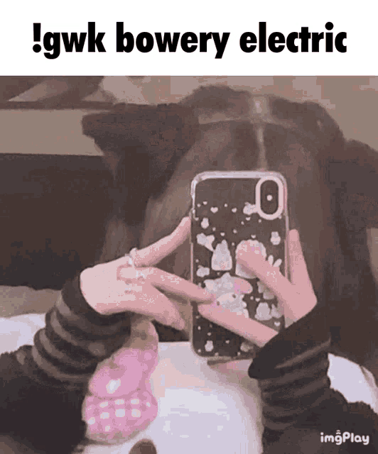 a person taking a picture of themselves with a phone case that says gwk bowery electric