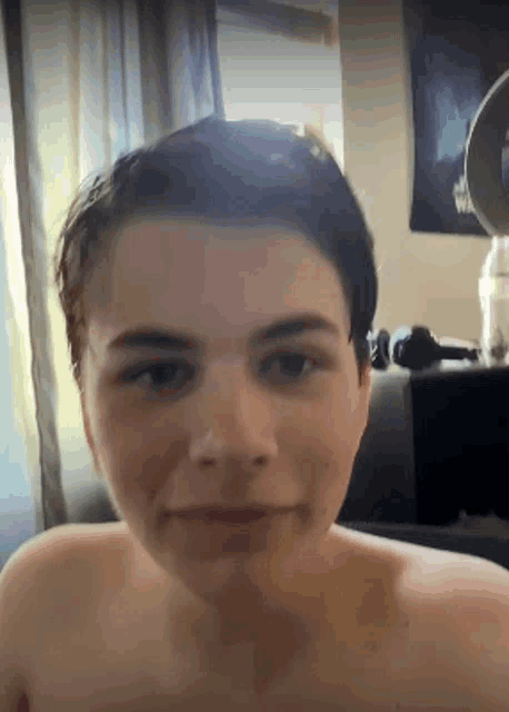 a close up of a person 's face without a shirt on
