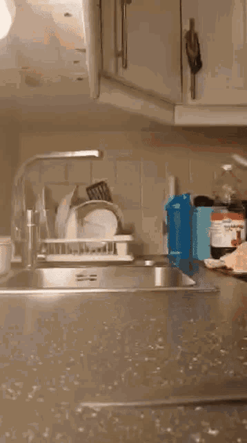 a kitchen sink with a white bowl on the counter top
