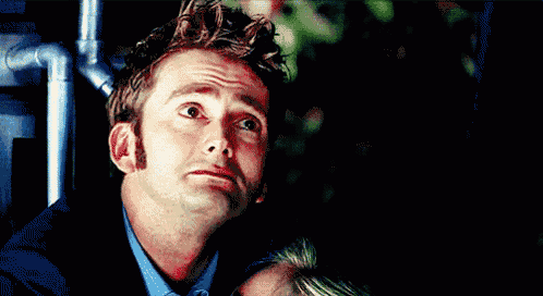 a close up of a man 's face with his eyes looking up