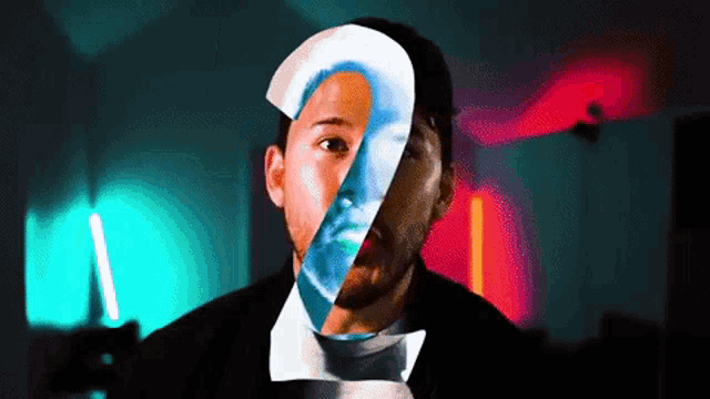 a man 's face is split in half with the number 2 on it