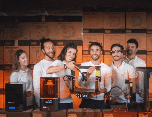 a group of people standing in front of boxes that say prusa on them