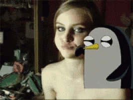 a penguin with a yellow beak is making a face next to a naked woman