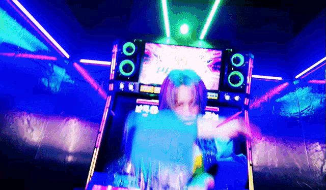a blurry picture of a person playing a video game with a screen that says ' arcade ' on it