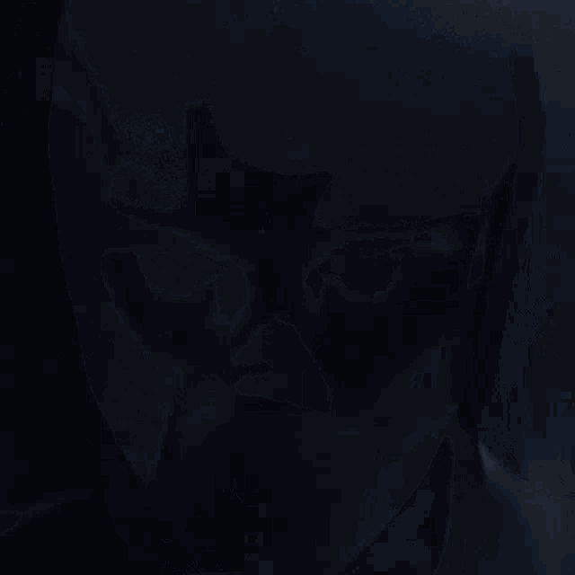 a close up of a person 's face with glowing eyes and a crescent moon on his forehead