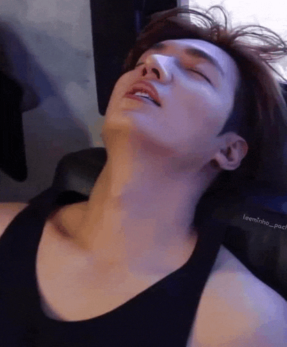 a close up of a man 's neck and chest while laying down .