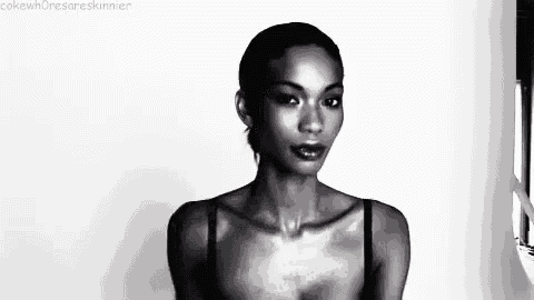 a black and white photo of a woman wearing a bra