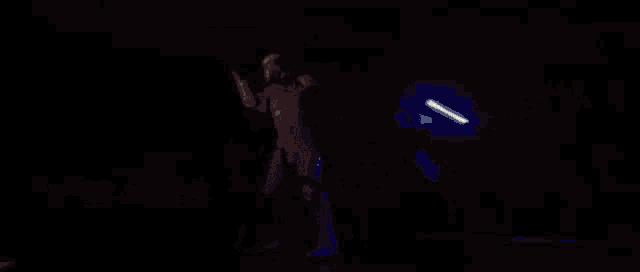a storm trooper is fighting another storm trooper in a dark room in a video game .