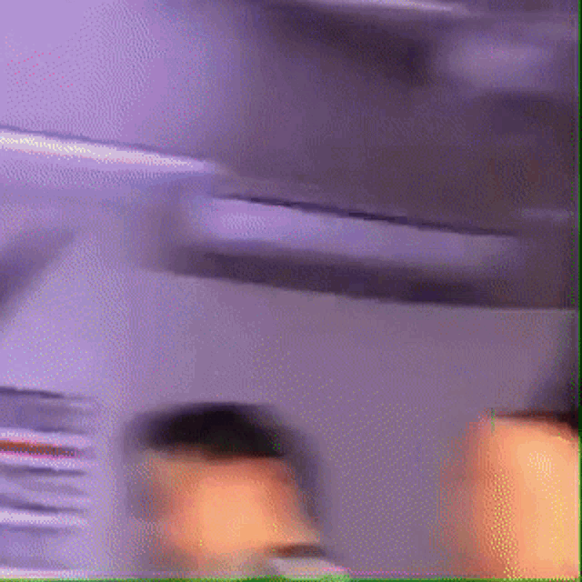 a blurry picture of a person 's face in a purple room