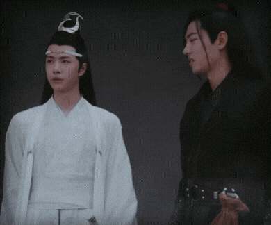 two men standing next to each other with one wearing a white kimono