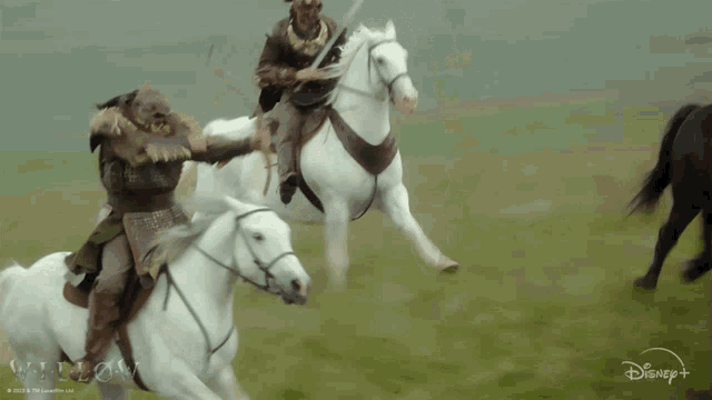 a man riding a white horse with a disney logo on the bottom right