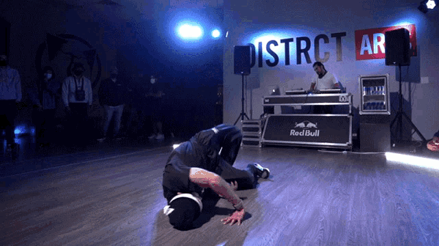 a man is kneeling down in front of a sign that says district