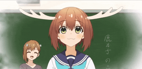 a girl with antlers on her head stands in front of a chalkboard with chinese writing
