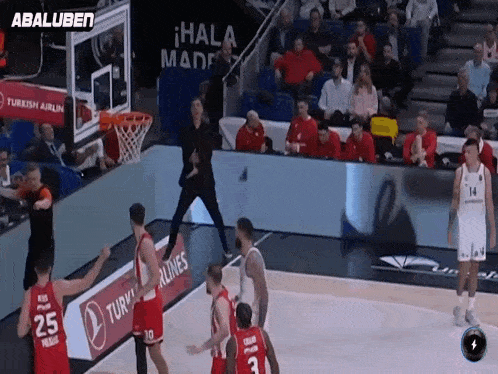 a basketball game is being played in front of a turkish airlines advertisement
