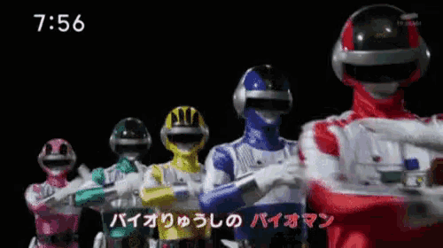 a group of power rangers are standing in a line with their arms crossed and the time is 6:56