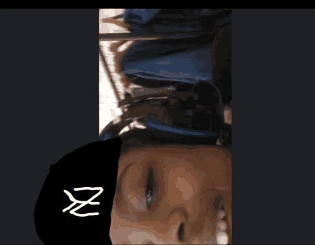a woman is wearing a black hat with the letter z on it