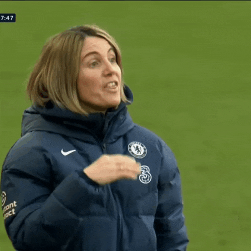 a woman in a jacket that says instant contact