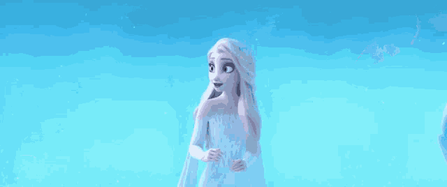 elsa from frozen 2 is standing in the snow wearing a white dress .