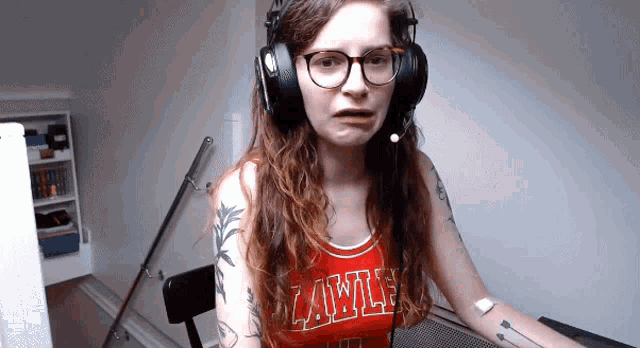 a woman wearing headphones and a red top that says lawle