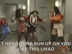 a group of women are dancing in a hallway while a man stands behind them .