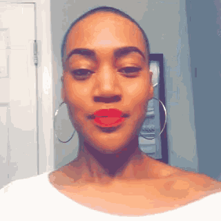 a woman with red lipstick and hoop earrings