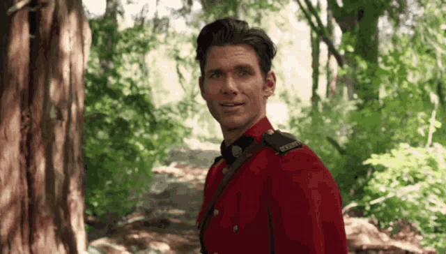 a man in a red uniform has a badge on his shoulder that says rcmp