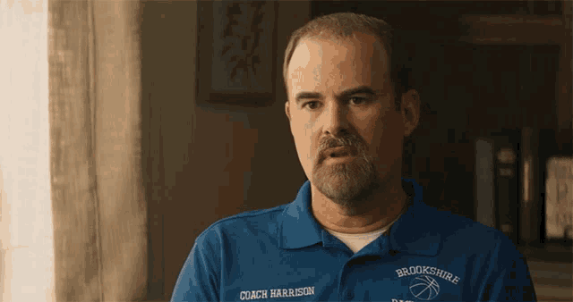 a man wearing a blue shirt that says brookshire on it