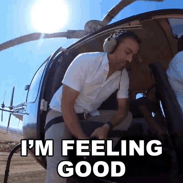 a man sitting in a helicopter with the words i 'm feeling good above him