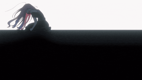 a silhouette of a woman with long hair is sitting on a black surface