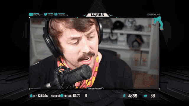 a man with a mustache is singing into a microphone on a screen that says scarf squad