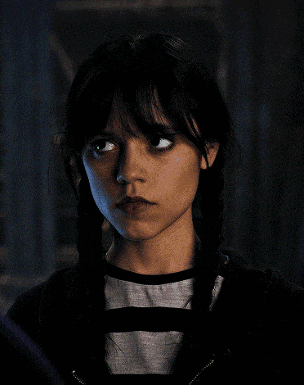 a close up of a woman 's face with pigtails and a striped shirt