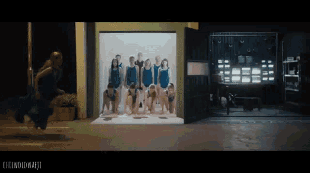 a group of people in blue swimsuits are standing in a garage with the words chilwoldwaeji on the bottom