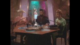 a group of people sitting at a table with a pyramid in the middle
