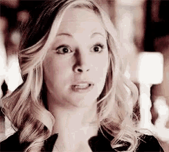 a close up of a woman 's face making a funny face .