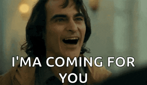 a man is laughing with the words `` i 'm coming for you '' written on his face .