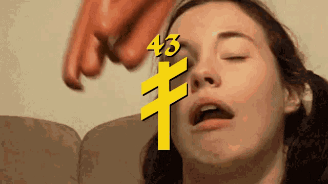 a woman with her eyes closed and the number 43 above her