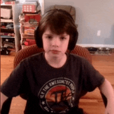a young boy wearing headphones and a shirt that says ' all the awesome people ' on it