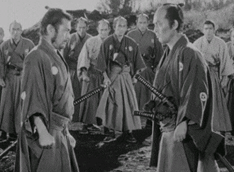 a black and white photo of a group of men in kimonos holding swords